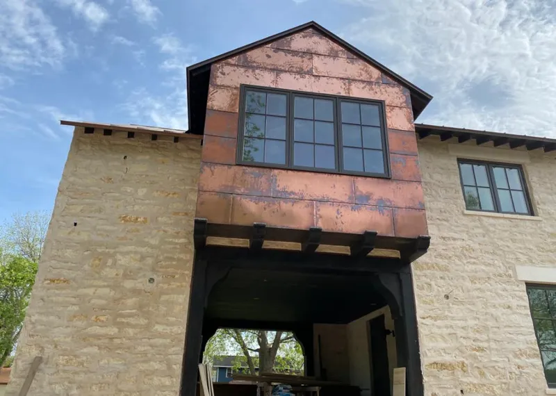 Copper metal panel facade on a stone building for Skylight Installation in Elizabethton